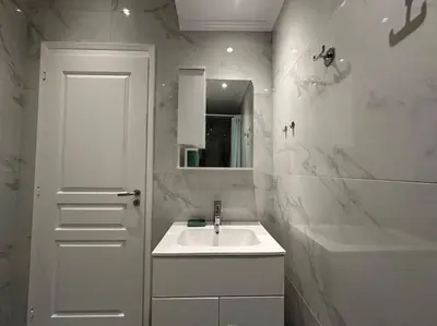 a white bathroom with a sink and a mirror at Comfort Downtown Marble, Koukaki Athens in Athens
