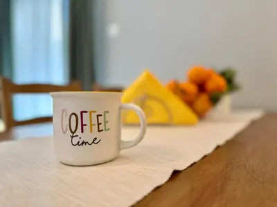 a coffee cup sitting on top of a table at Comfort Downtown Marble, Koukaki Athens in Athens