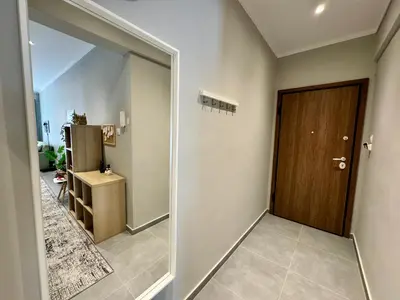 a hallway with a sliding door and a refrigerator at Comfort Downtown Marble, Koukaki Athens in Athens