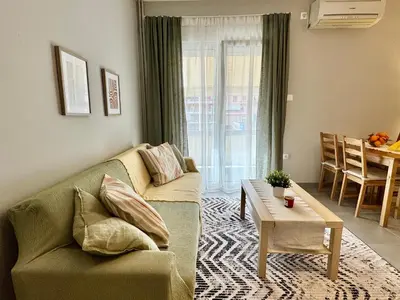 a living room with a couch and a table at Comfort Downtown Marble, Koukaki Athens in Athens