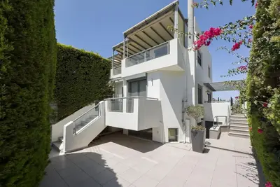 a white building with stairs and plants at Luxury Holiday Home near the Sea in Kalívia Thorikoú