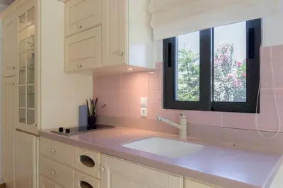 a white kitchen with a sink and a window at Luxury Holiday Home near the Sea in Kalívia Thorikoú