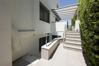 a set of stairs leading up to a building at Luxury Holiday Home near the Sea in Kalívia Thorikoú