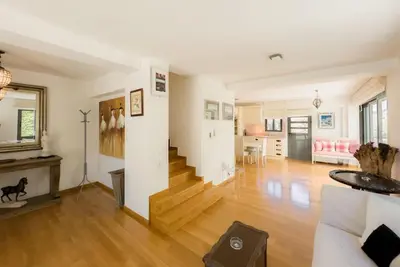 a living room with a wooden floor and a living room at Luxury Holiday Home near the Sea in Kalívia Thorikoú