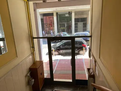 an open door to a street with a car outside at Urban Chic Flat Pagrati Athens in Athens