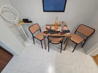 a dining room table with four chairs in a room at Urban Chic Flat Pagrati Athens in Athens