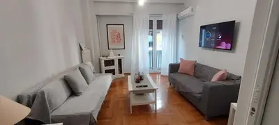 a living room with a couch and a table at Urban Chic Flat Pagrati Athens in Athens
