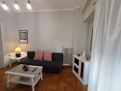 a living room with a couch and a table at Urban Chic Flat Pagrati Athens in Athens