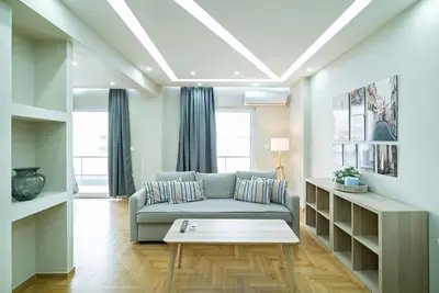 a living room with a couch and a table at Filoxenia MG projects Alimos in Athens