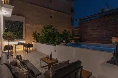 a living room with a couch and a swimming pool at Perth Luxury Living, Athens in Athens
