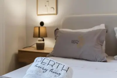 a bed with a pillow with the wordsfaith happy happy furry at Perth Luxury Living, Athens in Athens