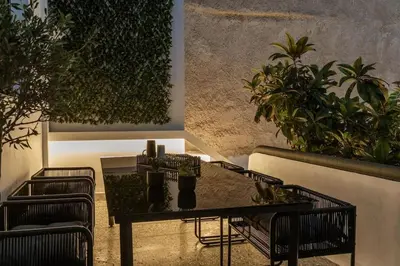 a patio with a table and chairs and plants at Perth Luxury Living, Athens in Athens