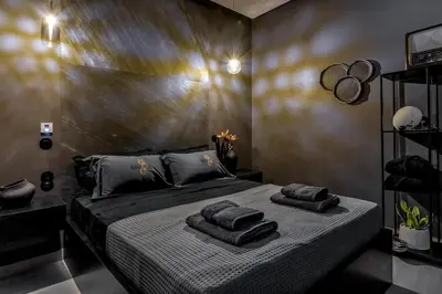 a bedroom with a bed with towels on it at Perth Luxury Living, Athens in Athens