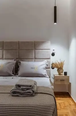 a bedroom with a bed with two towels on it at Perth Luxury Living, Athens in Athens