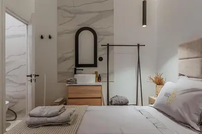a bedroom with a bed with a sink and a mirror at Perth Luxury Living, Athens in Athens