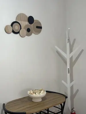 a table with a bowl of mushrooms and hats on a wall at Acropolis Modern Apartment in Athens