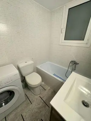 a bathroom with a toilet and a sink and a washing machine at Acropolis Modern Apartment in Athens