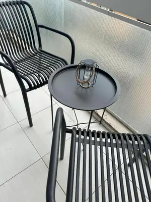 a black table with a purse on it next to a chair at Acropolis Modern Apartment in Athens