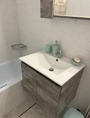 a bathroom with a sink and a bath tub at Acropolis Modern Apartment in Athens
