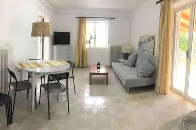 a living room with a couch and a table at Fysis Panorama spectacular view in Porto Rafti