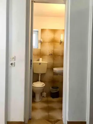a bathroom with a toilet and a sink at Fysis Panorama spectacular view in Porto Rafti