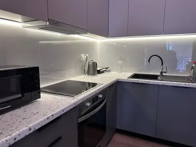 a white kitchen with a sink and a microwave at Athenian Escape 2BR, 2BA, Stylish Fully Reno Apt in Athens