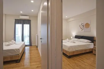 a hotel room with two beds and a mirror at Athenian Escape 2BR, 2BA, Stylish Fully Reno Apt in Athens