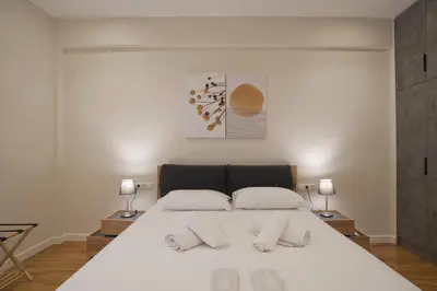 a bedroom with a large white bed with two pillows at Athenian Escape 2BR, 2BA, Stylish Fully Reno Apt in Athens