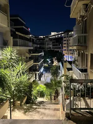 a city street at night with buildings at Green studio near Acropolis in Athens