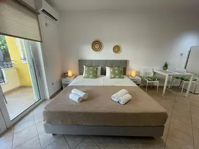 a bedroom with a bed with two towels on it at Green studio near Acropolis in Athens