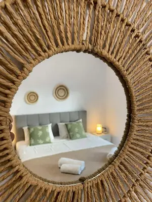 a mirror reflecting a bedroom with a bed in it at Green studio near Acropolis in Athens