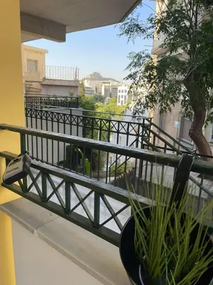 a balcony with a railing and a plant at Green studio near Acropolis in Athens