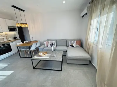 a living room with a couch and a table at PUERTO VILLA, Best Location in Porto Rafti in Porto Rafti