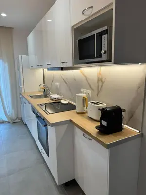 a kitchen with a counter with a sink and a microwave at PUERTO VILLA, Best Location in Porto Rafti in Porto Rafti