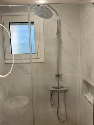 a shower with a glass door in a bathroom at PUERTO VILLA, Best Location in Porto Rafti in Porto Rafti