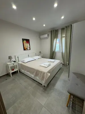 a bedroom with a large bed in a room at PUERTO VILLA, Best Location in Porto Rafti in Porto Rafti