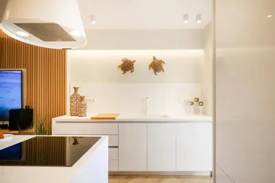 a kitchen with white cabinets and a sink at Glyfada Platinum Résidence in Athens