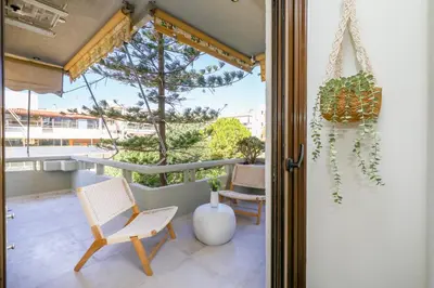 a patio with two chairs and a table at Glyfada Platinum Résidence in Athens