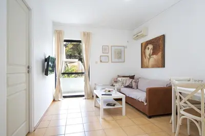 a living room with a couch and a table at Lovely Cosy Apartment In Papagos in Athens
