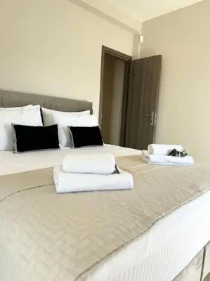 a bedroom with a bed with towels on it at R&G luxury accommodation Varkiza in Vari