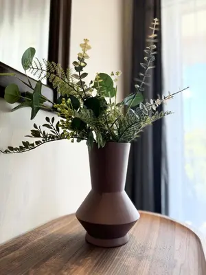 a vase filled with plants sitting on a table at R&G luxury accommodation Varkiza in Vari