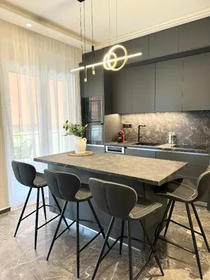 a kitchen with a large table with four chairs at R&G luxury accommodation Varkiza in Vari