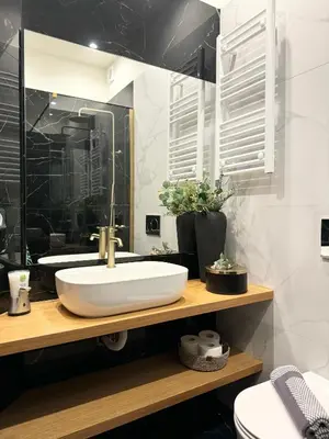 a bathroom with a white sink and a mirror at R&G luxury accommodation Varkiza in Vari