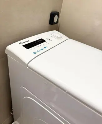 a white washer and dryer in a room at R&G luxury accommodation Varkiza in Vari