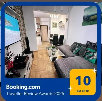 a living room with a couch and a table at New condo Athens Kallimarmaro in Athens