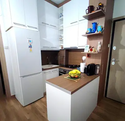 a kitchen with a white refrigerator and a counter top at New condo Athens Kallimarmaro in Athens