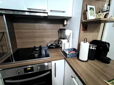 a kitchen with a stove and a counter top at New condo Athens Kallimarmaro in Athens