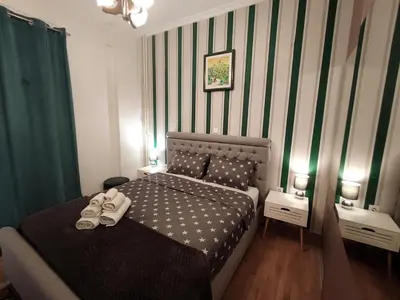 a bedroom with a bed with shoes on it at New condo Athens Kallimarmaro in Athens