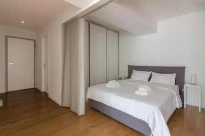 a bedroom with a large white bed with white sheets at Athens Trikoupi Suite E2 in Athens