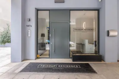 a front door to a furniture store with a sign that reads trump residence at Athens Trikoupi Suite E2 in Athens